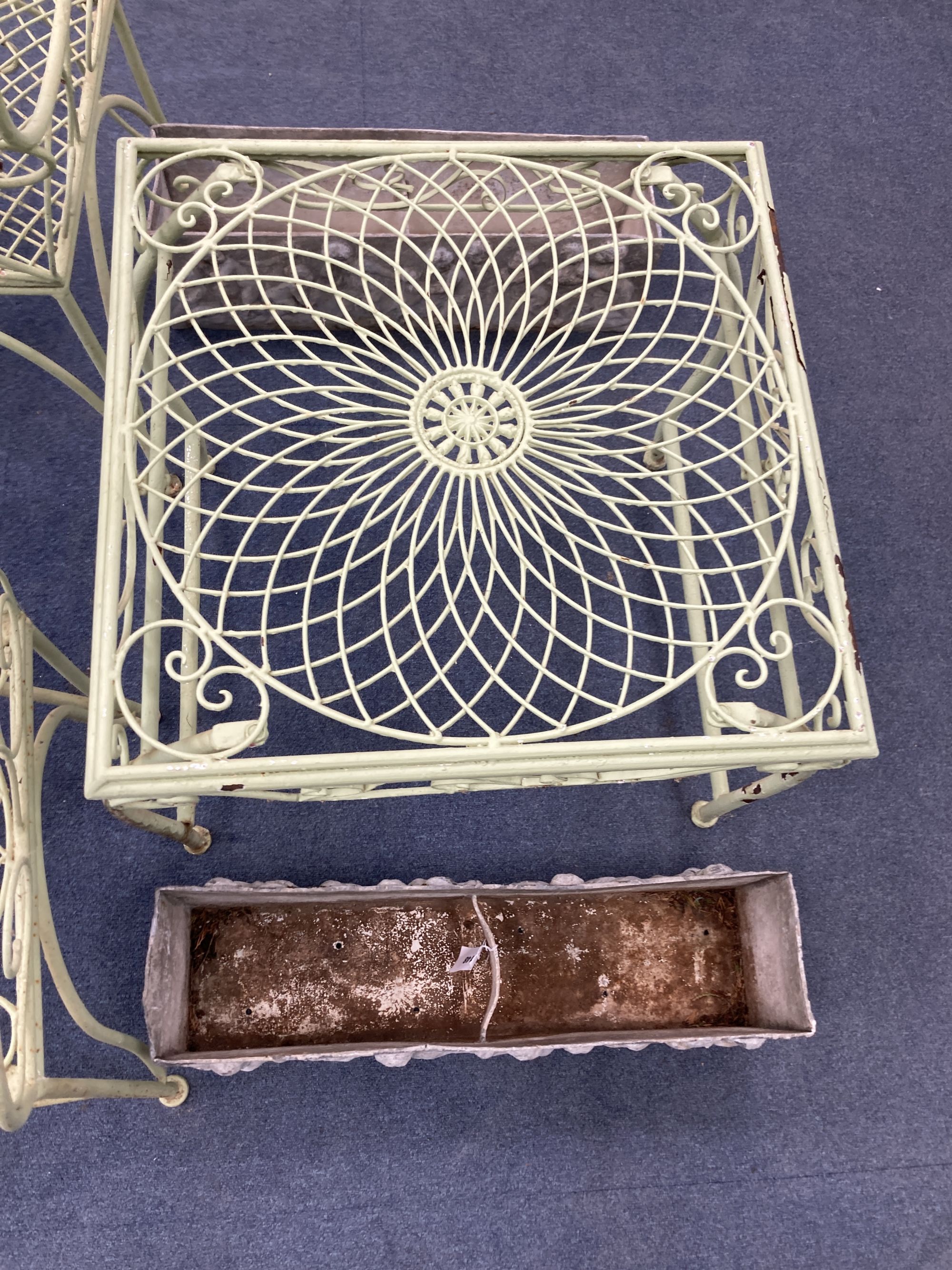 A French painted wrought iron garden suite comprising a pair of benches, length 122cm, depth 62cm, height 108cm, a pair of chairs and a table